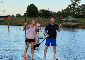 Lauren and Matt Merritt paddle boarding