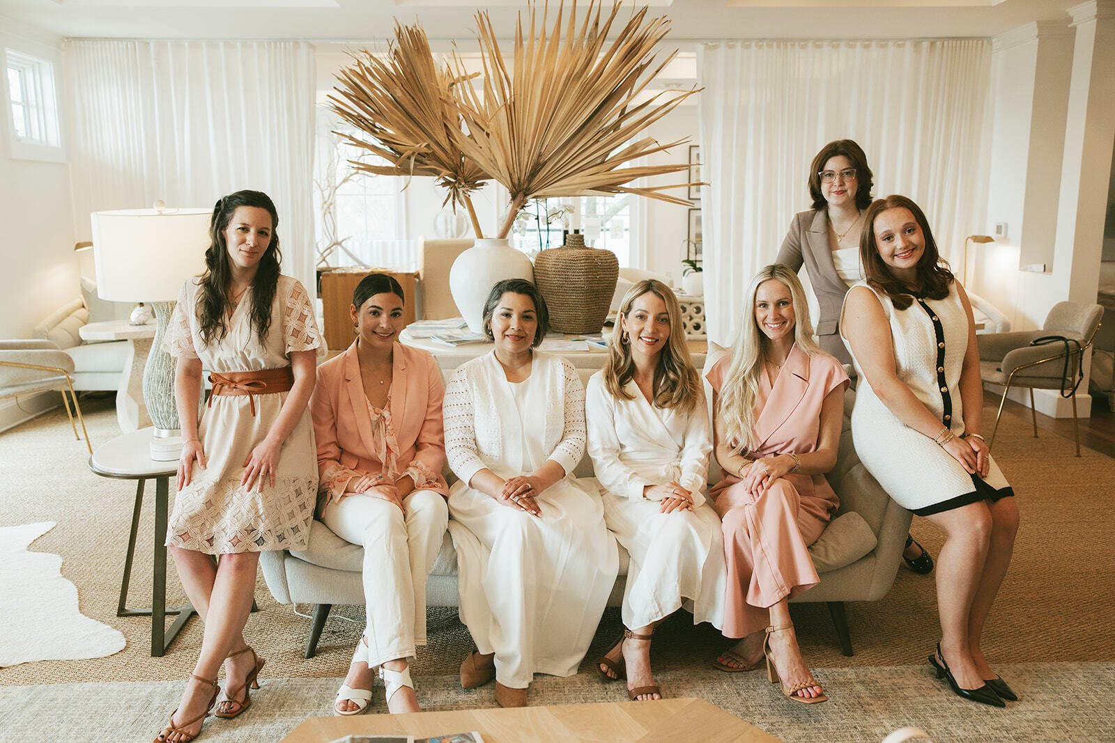 My Pink Lawyer team seated together in their Pensacola office